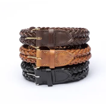 A stack of three coiled Inverted Plait Belts in Full Grain Vegetable Tanned Leather