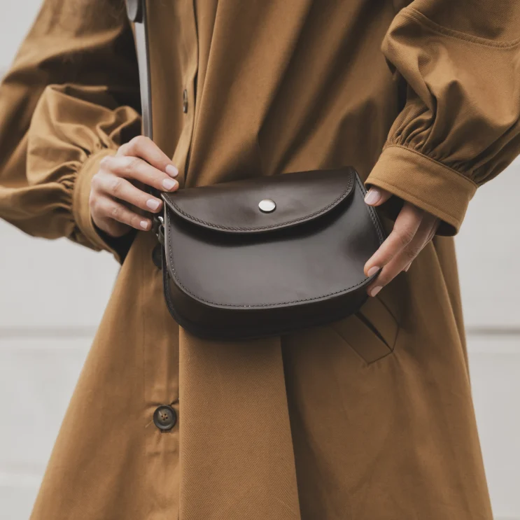 Woman wearing The Brum Shoulder Bag in Bridle Brown close up