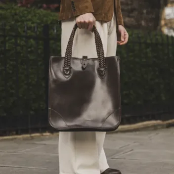 Man holding The Bodleian Tote Bag in Bridle Brown