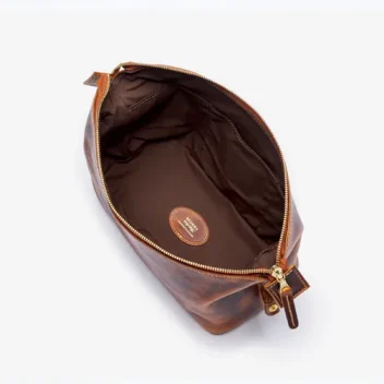 An open, unzipped view of The Leighton Wash Bag in Badalassi - Wax Cognac