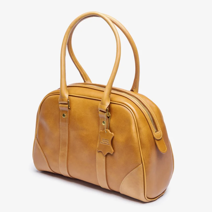 The Chetham Boston Bag in Red Rum Tan side view
