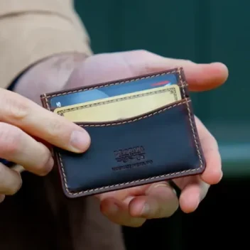 Hands holding the Slimline Credit Card Case in Badalassi – Wax Tobacco